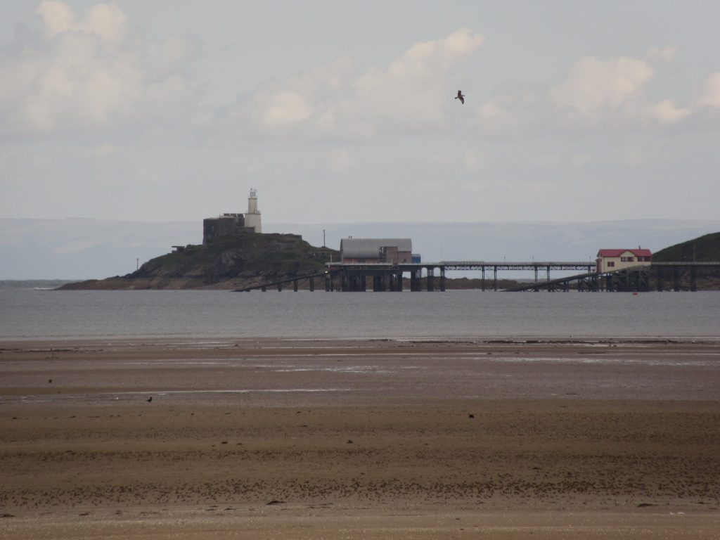 View of Mumbles Pier and Lighthouse, from Blackpill. 